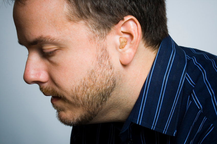 Adult male wearing a hearing aid.