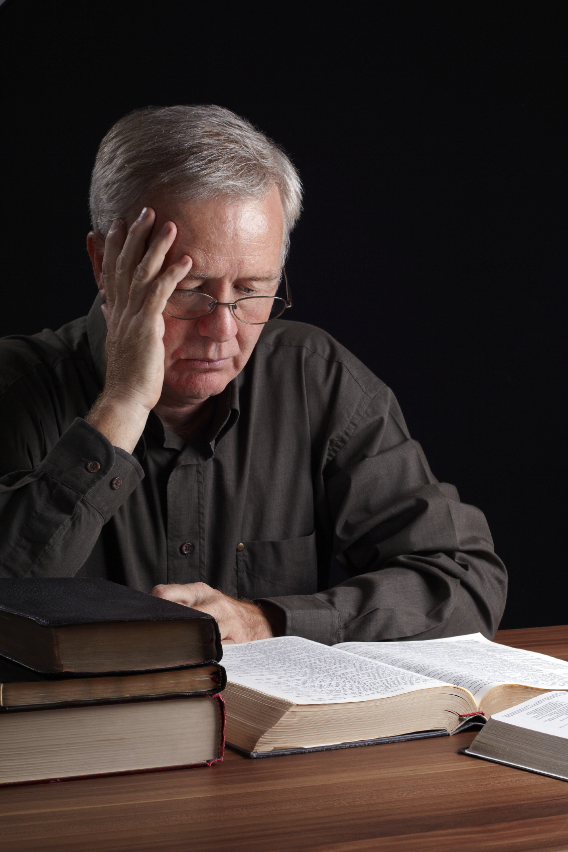 Senior pastor reading, meditating and searching spiritual light