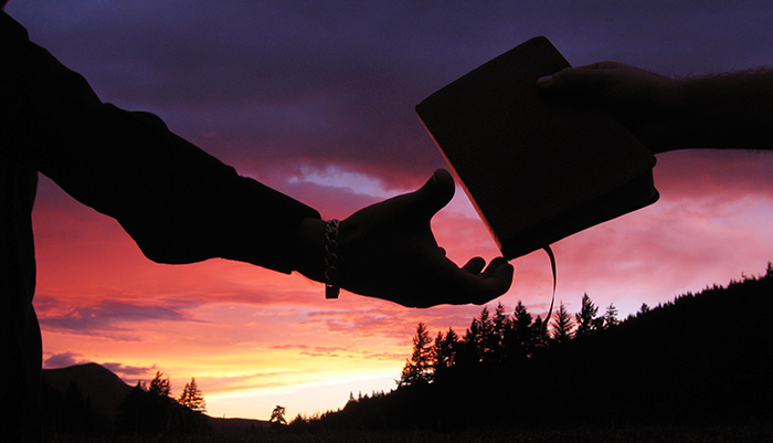 bible-hand-silhouette-sharing-silhouette-sunset